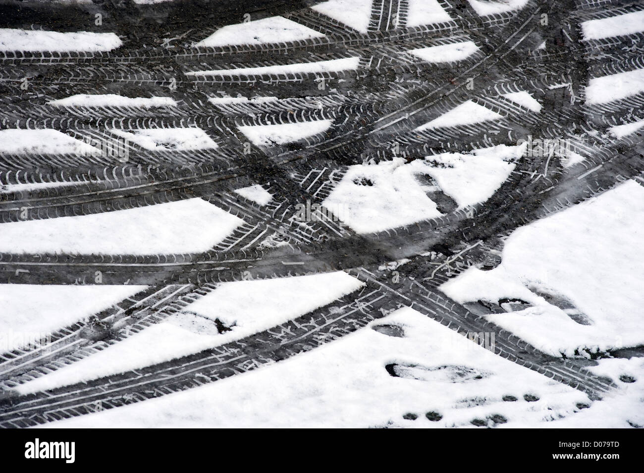 Prints from a car in the melting snow Stock Photo