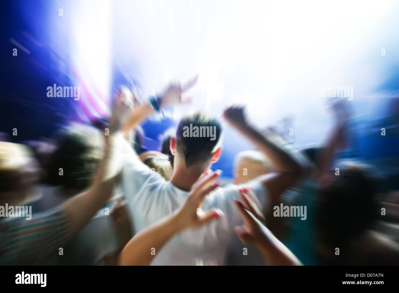 People with hands up having fun on a music concert / disco party. Stock Photo