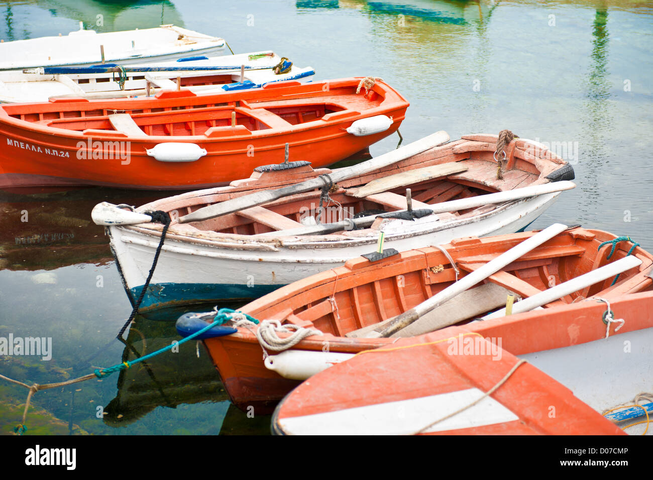 Colorful wooden row boats moored in a harbor in Aliki, on the island of Paros, Greece Stock Photo
