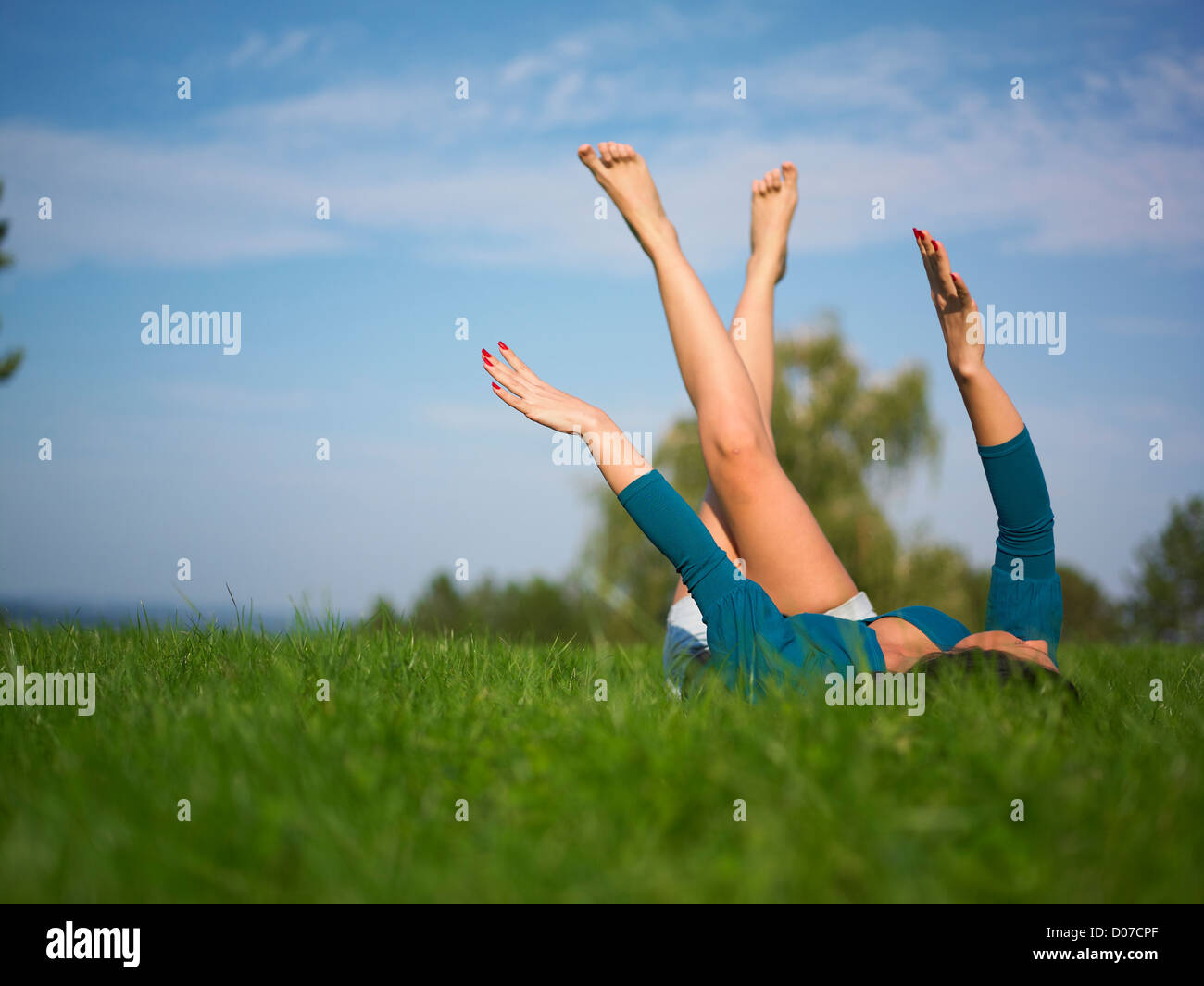 Young woman relaxing in park on green grass Stock Photo - Alamy