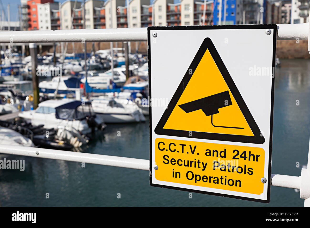 Sign warning of CCTV and 24 hour security patrols around the marina, St Helier, Jersey, Channel Islands, UK Stock Photo