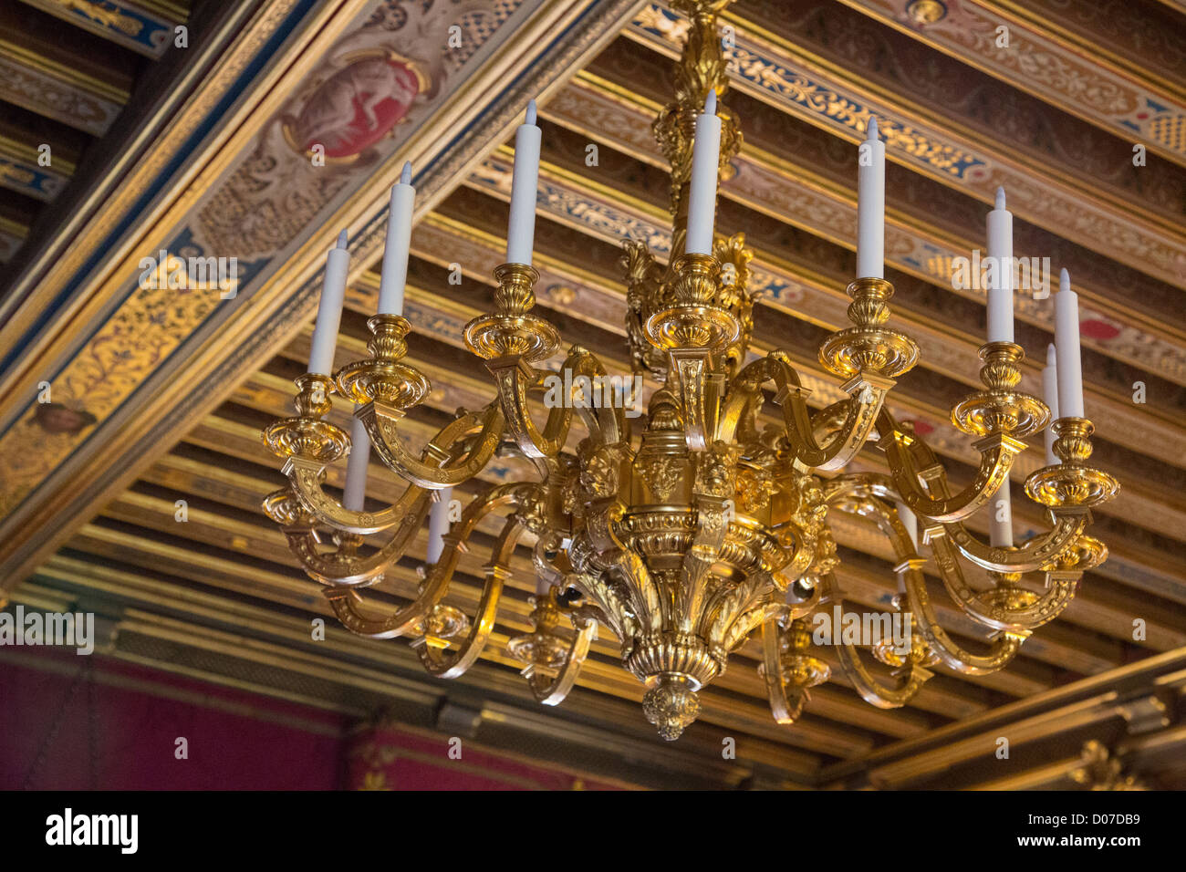 LOUIS XIV PERIOD DOLPHIN CHANDELIER IN GILDED BRONZE DECORATED BEAMED CEILING KING'S SALON KING LOUIS XIV'S BEDROOM CHATEAU DE Stock Photo
