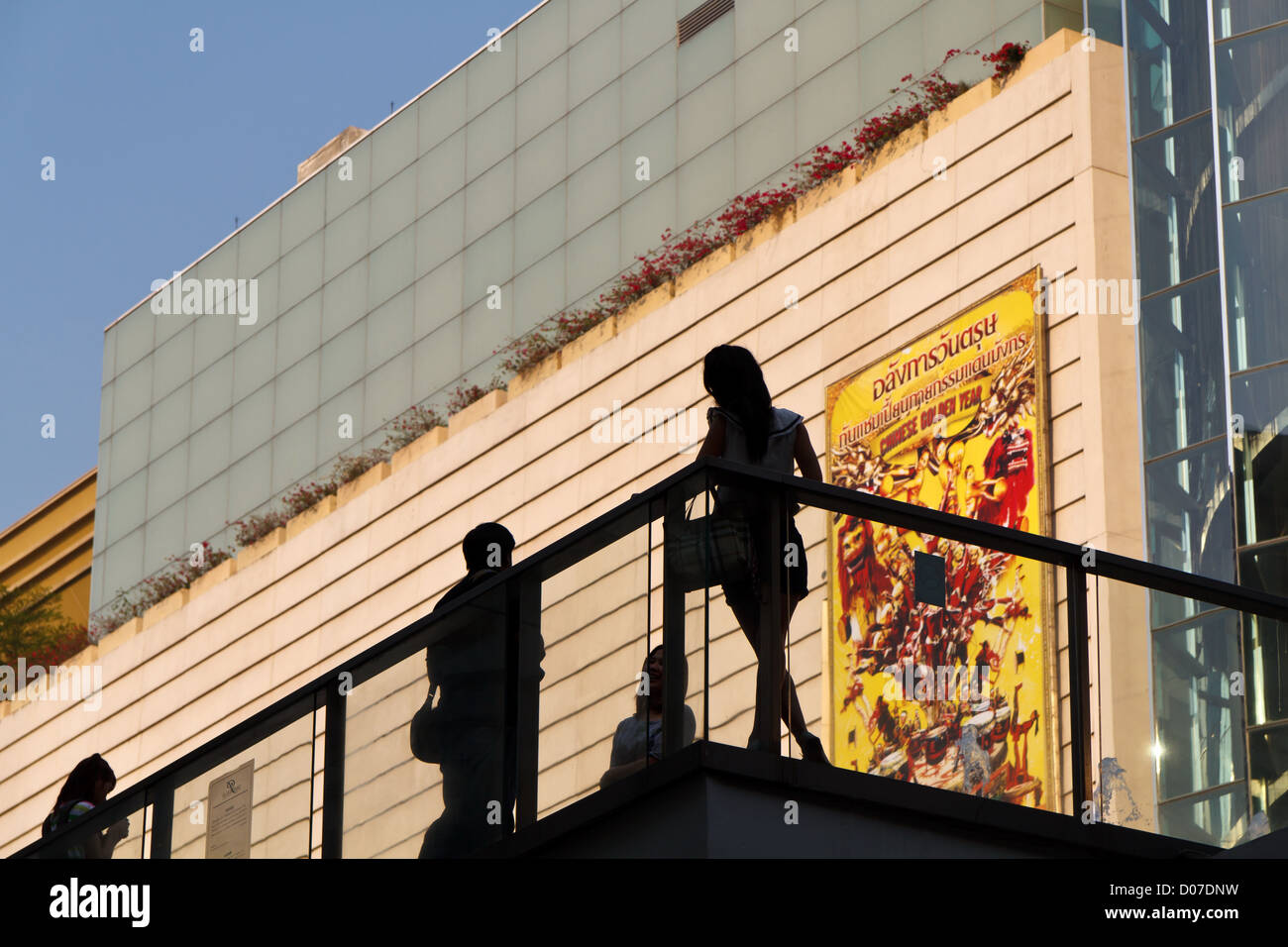 Silhouette of Women on a Balustrade at Siam Square in Bangkok, Thailand Stock Photo