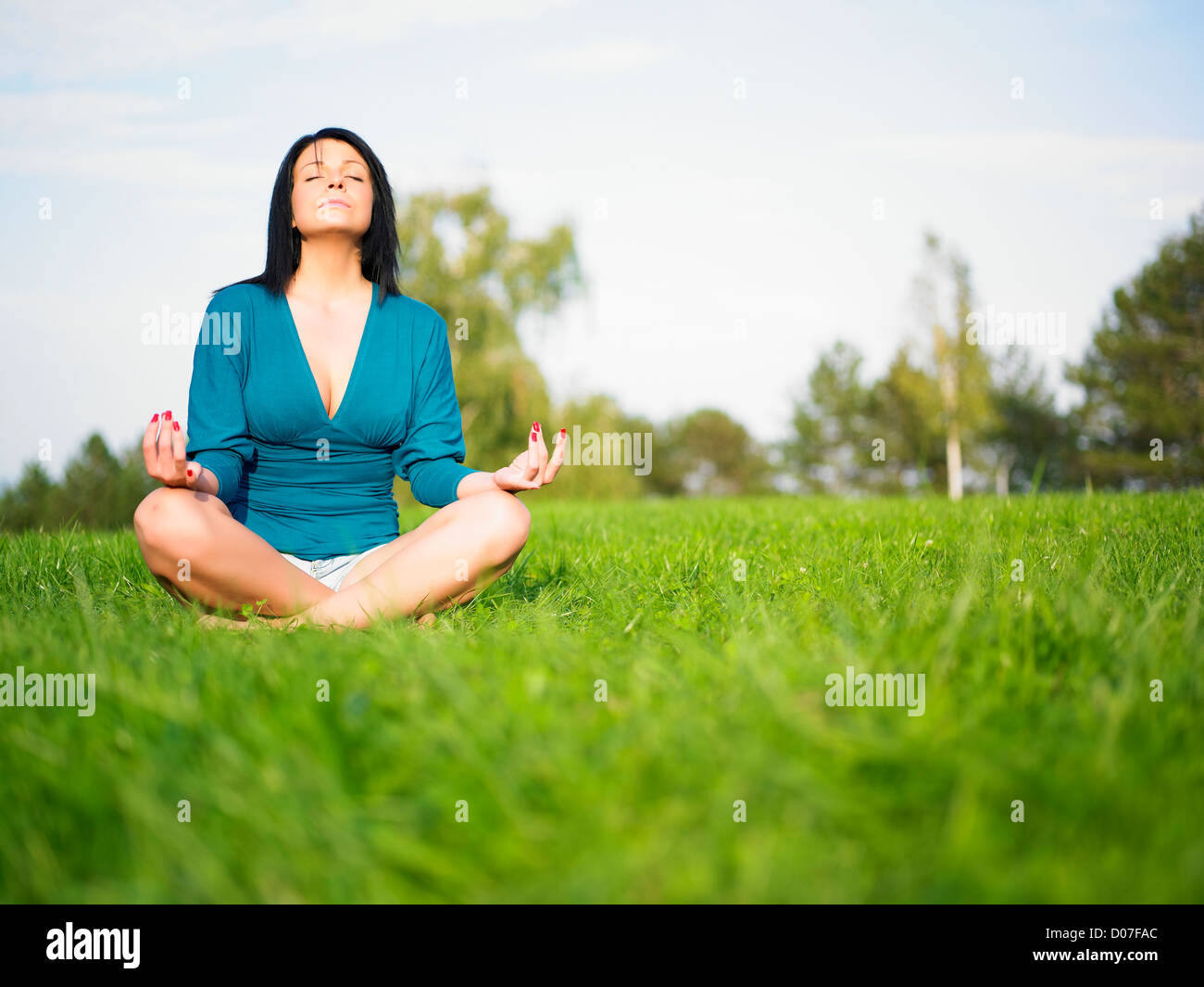 Young woman relaxing in park on green grass Stock Photo - Alamy