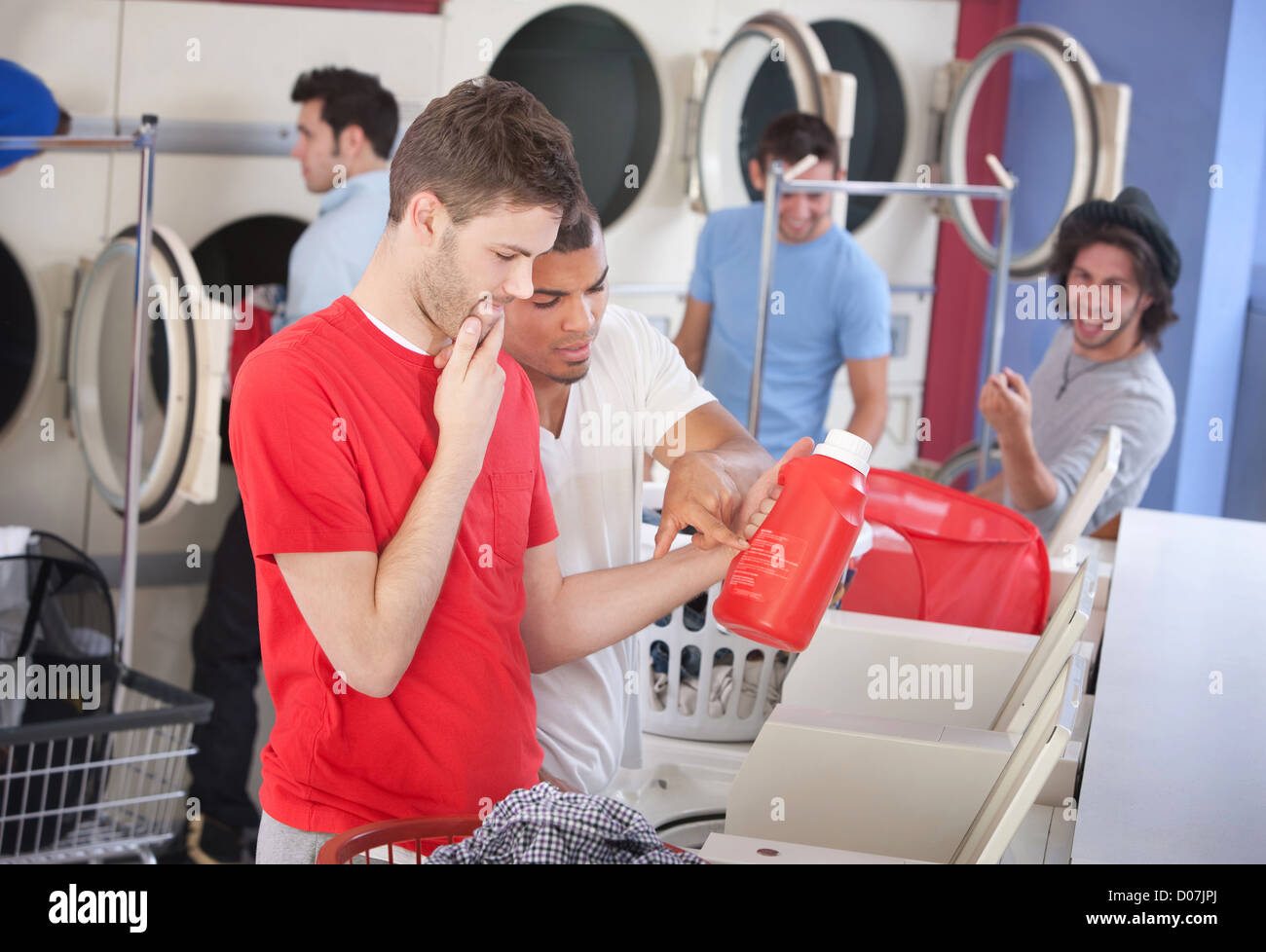 Two confused men read the instructions on the detergent or conditioner