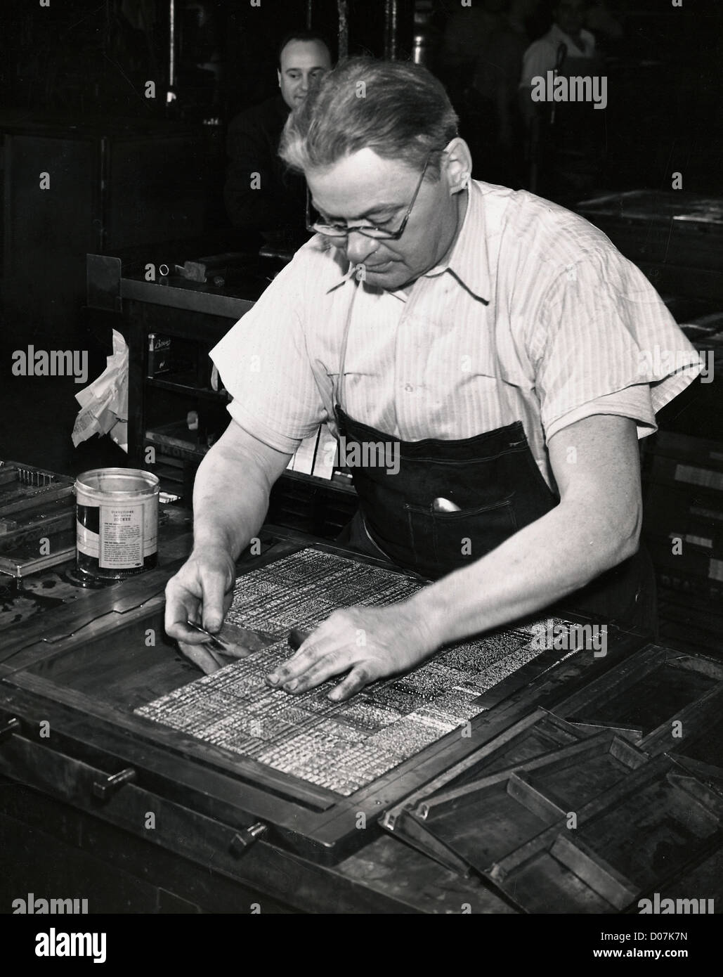 Workman in process of making newspaper plate Stock Photo