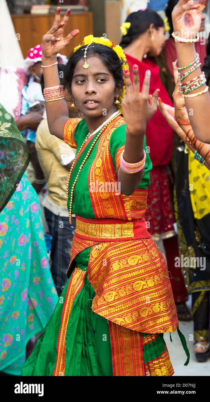 Indian girls in traditional dress dancing at a festival in the streets of Puttaparthi. Andhra Pradesh, India Stock Photo