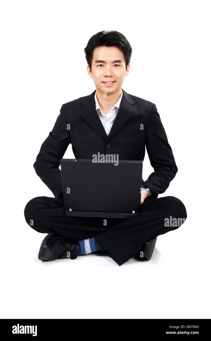 Asian business man sitting on floor with laptop Stock Photo - Alamy