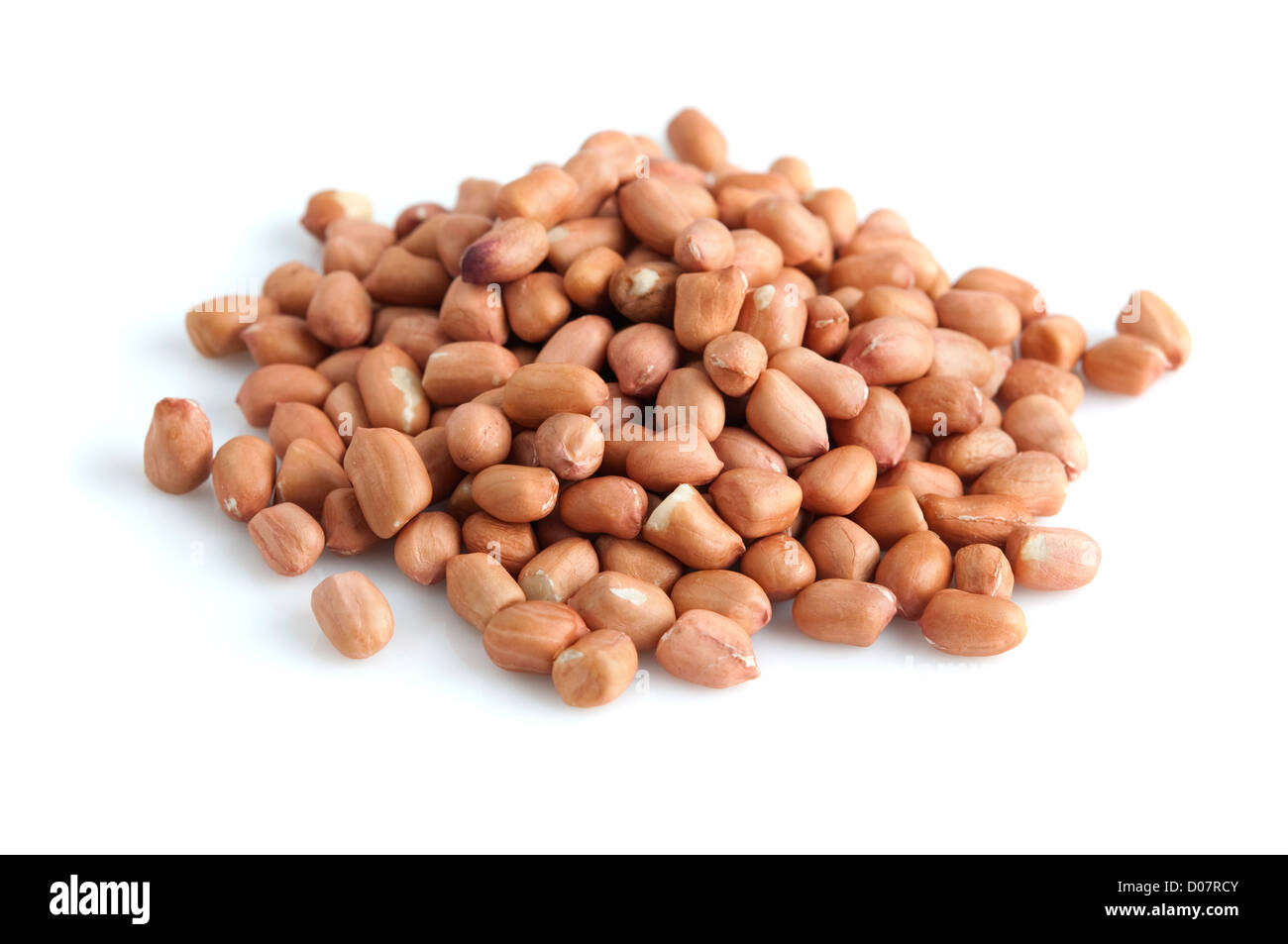 Pile of peanuts with skin isolated on white. Stock Photo