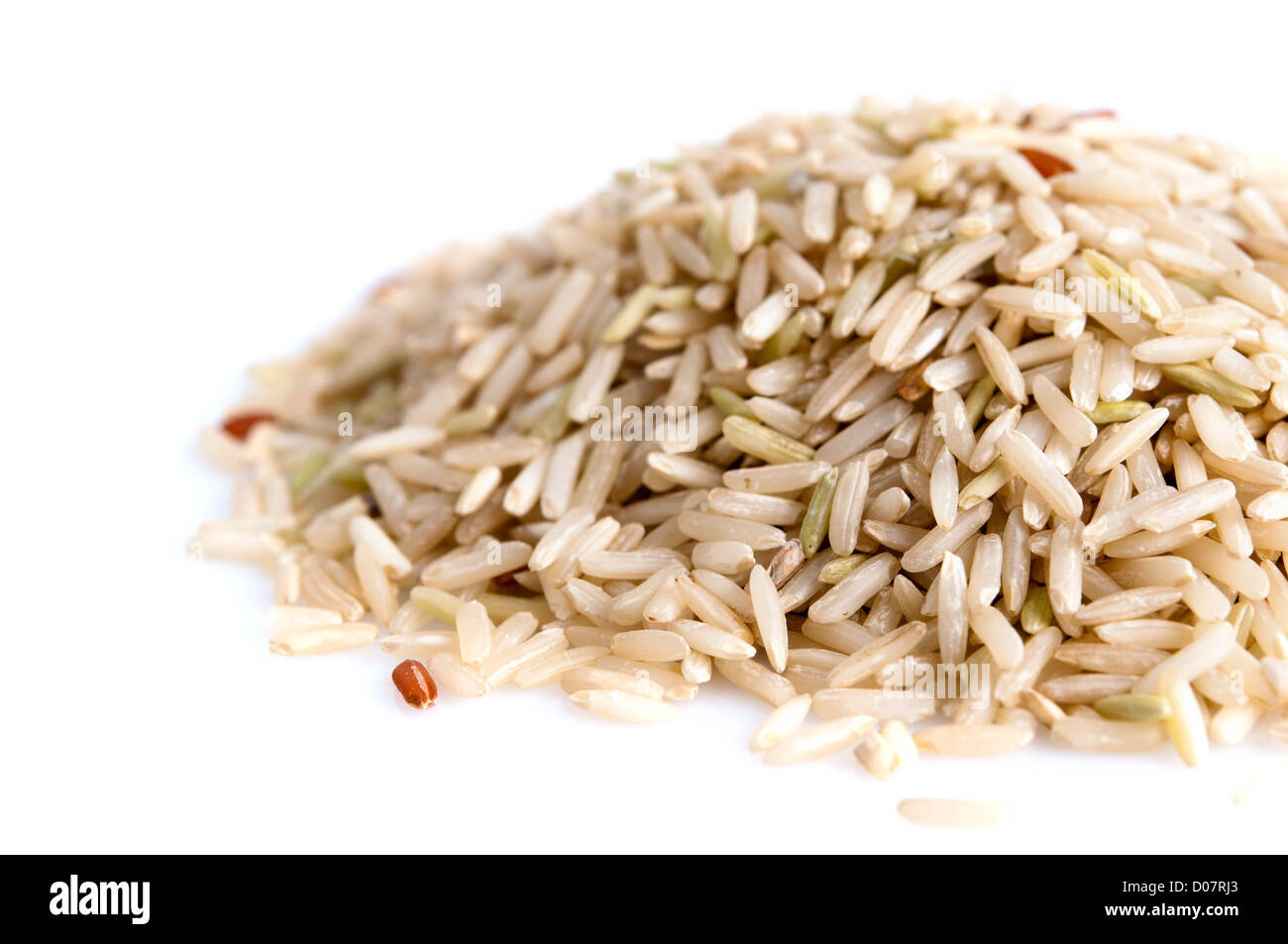 Pile of brown rice isolated on white background Stock Photo - Alamy