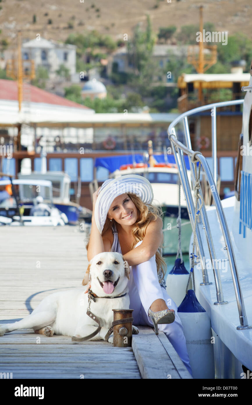 Young girl with her dog going on voyage Stock Photo
