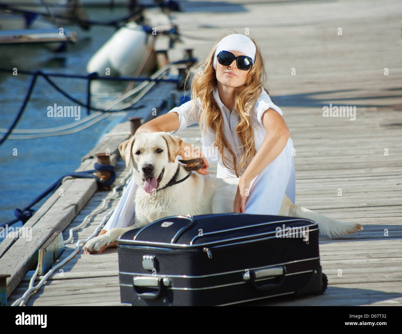 Young girl with her dog going on voyage Stock Photo