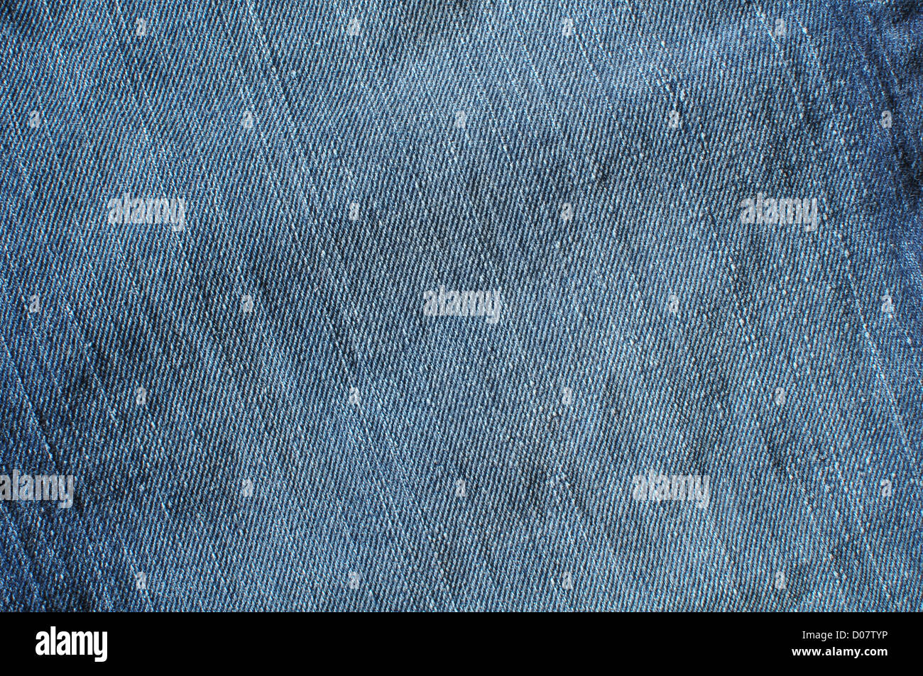 Fabric of different kinds for sewing clothes. Denim, costume, checkered,  blue red fabric for sewing clothes. Textile folded into a pile. Stock Photo