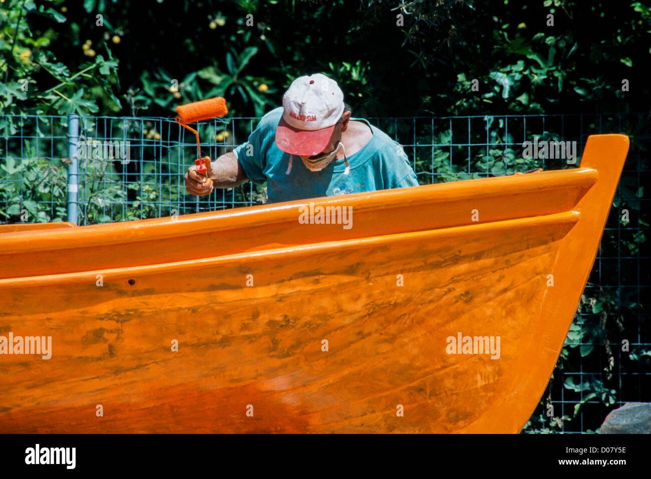 A man painting his boat Stock Photo