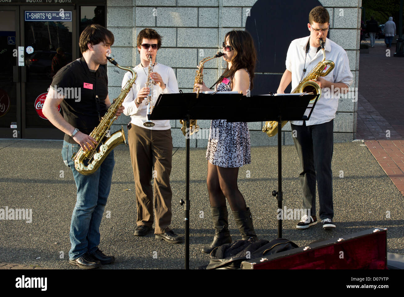 Young buskers /street musicians play brass instruments in the evening