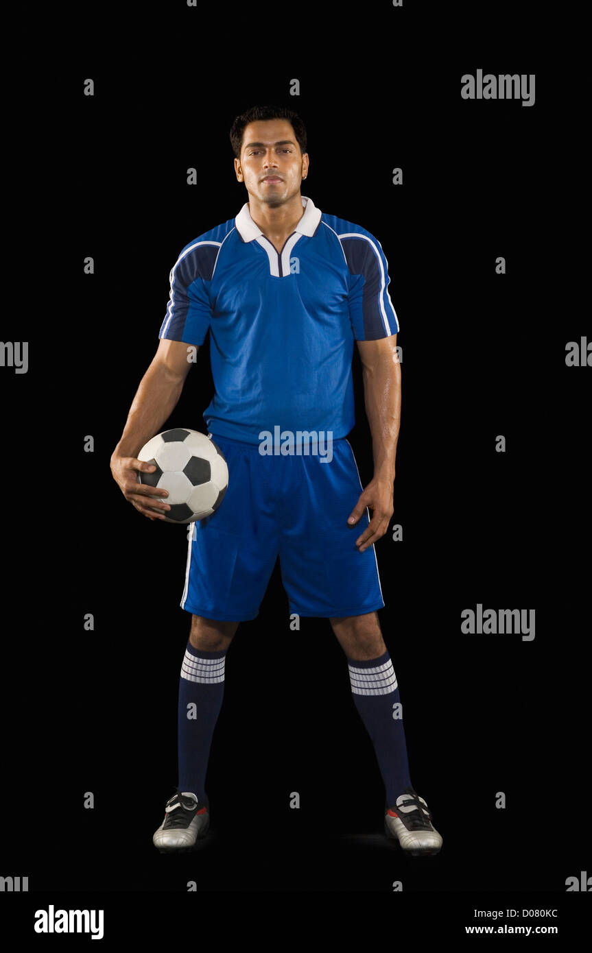 Portrait of a man holding a soccer ball Stock Photo - Alamy