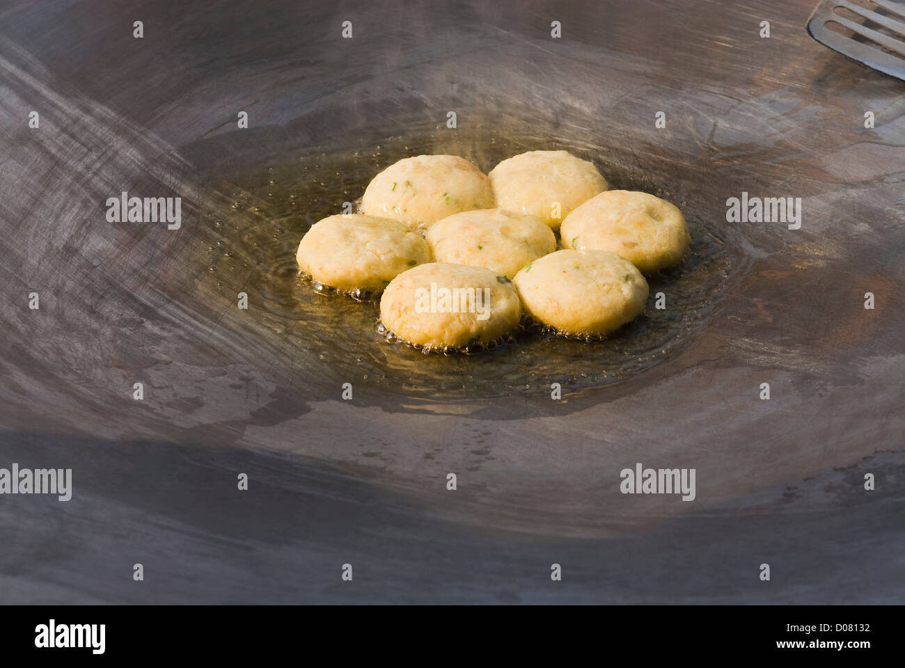 Closeup of aloo tikkis being fried on a griddle, Delhi, India Stock