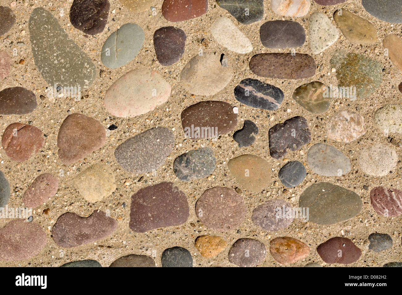 Colorful Rocks and Stones in Sand Background Stock Photo