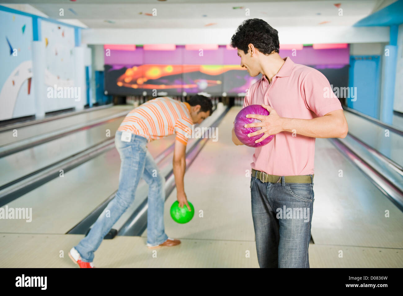 Two young men playing ten pin bowling Stock Photo Alamy