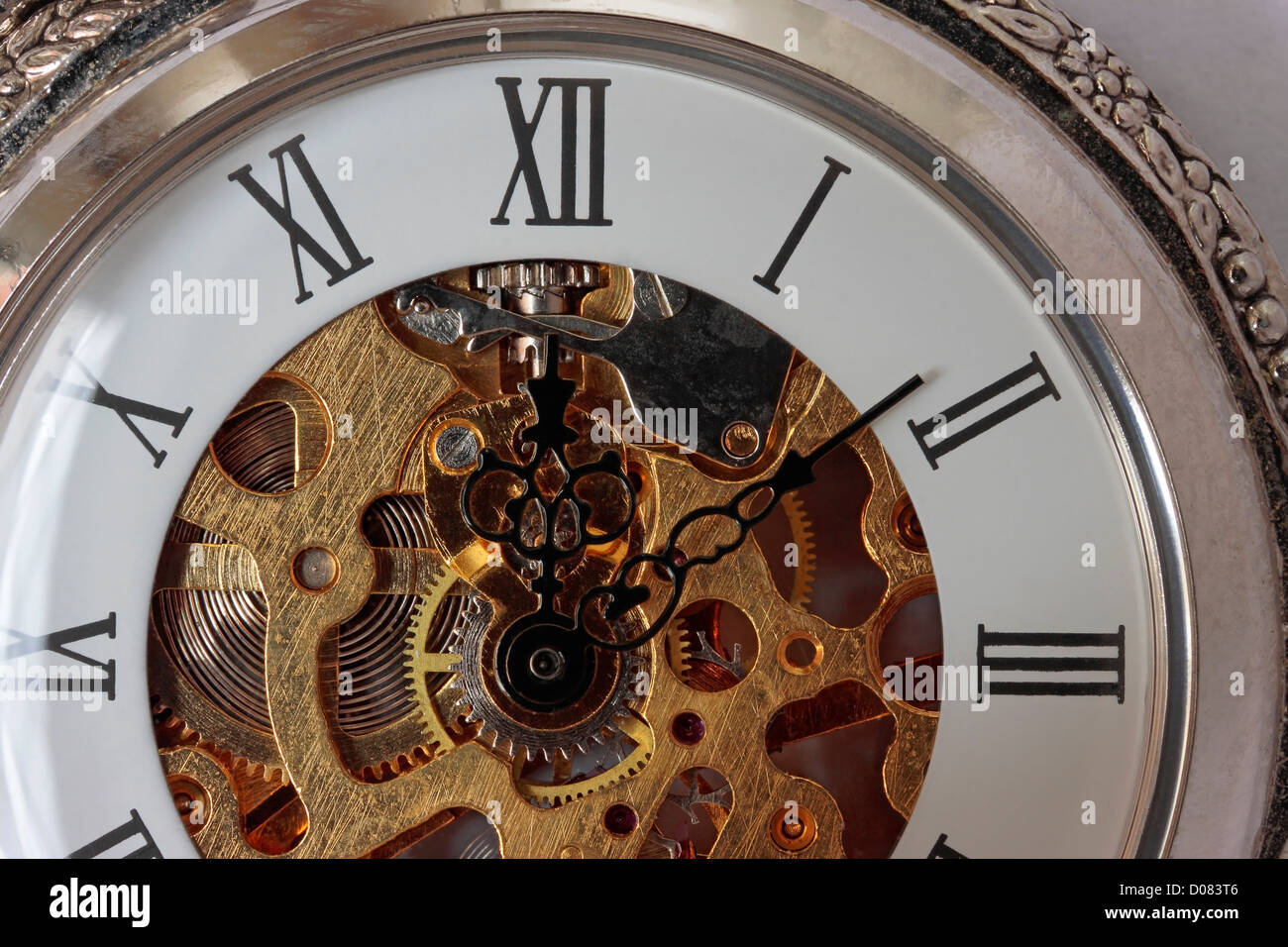 Pocket Watch with Ornate Hands and See Through Face close up Stock Photo