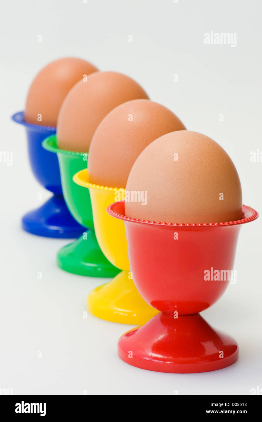 Four colourful egg holders in row Stock Photo