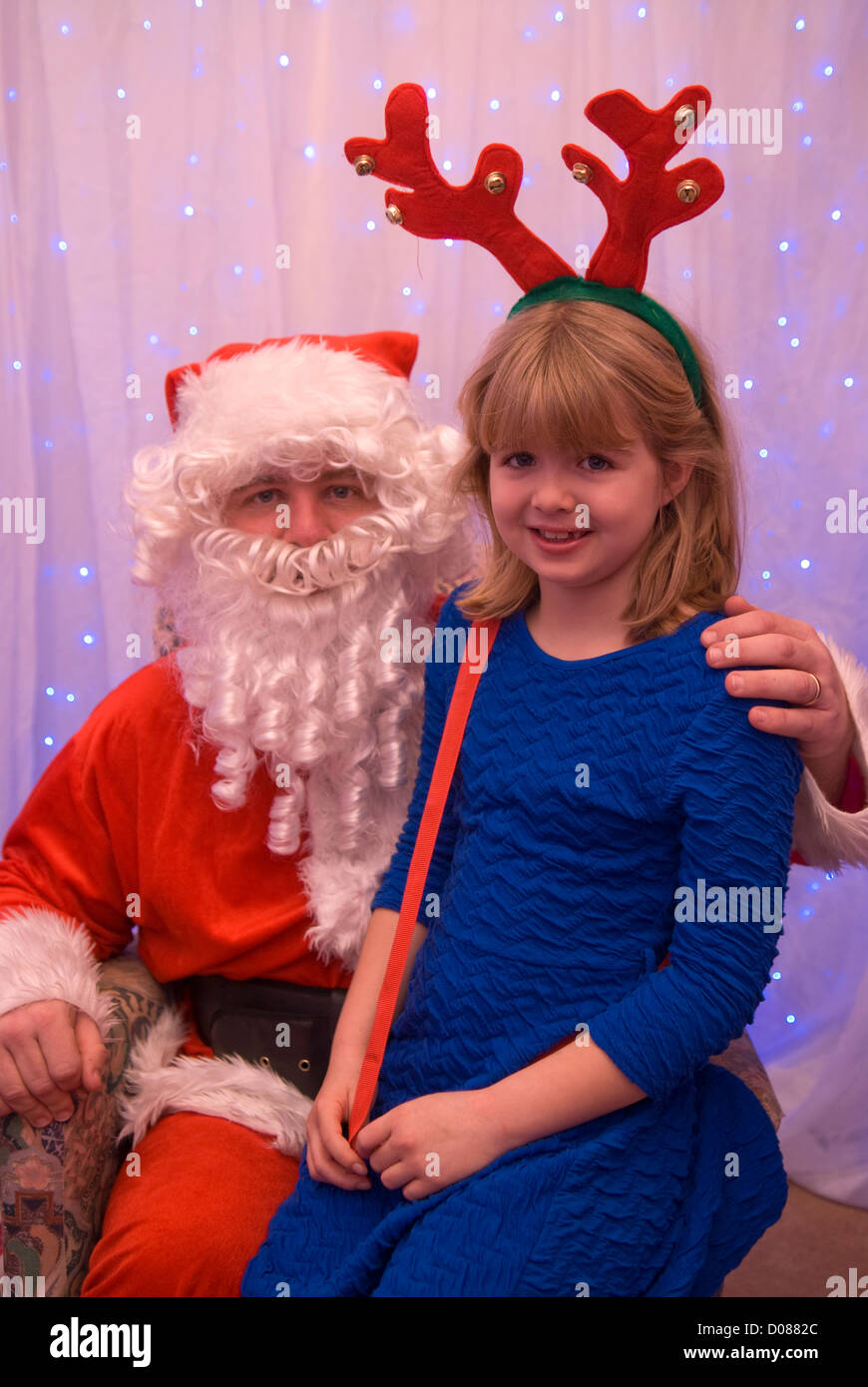 8 year old girl in grotto with Father Christmas at a school Christmas