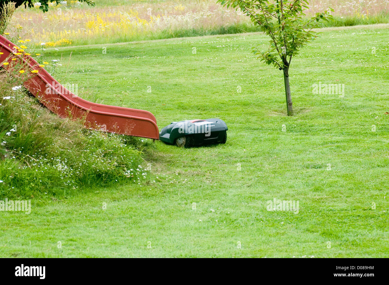 husqvarna robotic robot mower mowers grass cutter cutting the garden hi tech Stock Photo