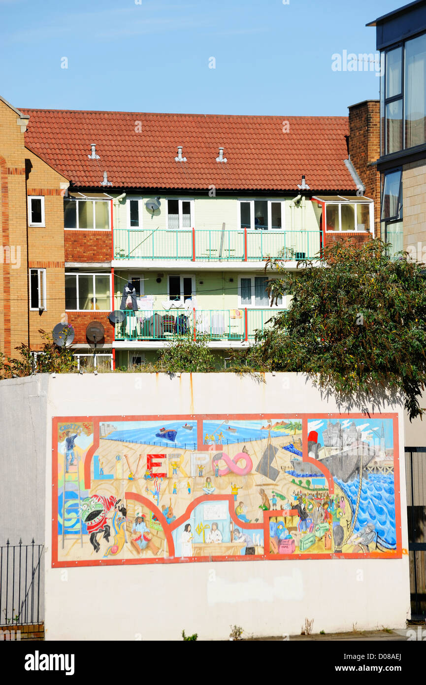 Graffiti on a wall in front of inner city housing in Liverpool. Stock Photo