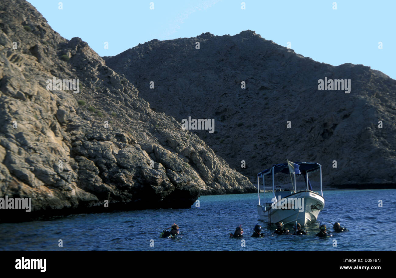 Tourists from a boat scuba-diving near Muscat Oman Stock Photo