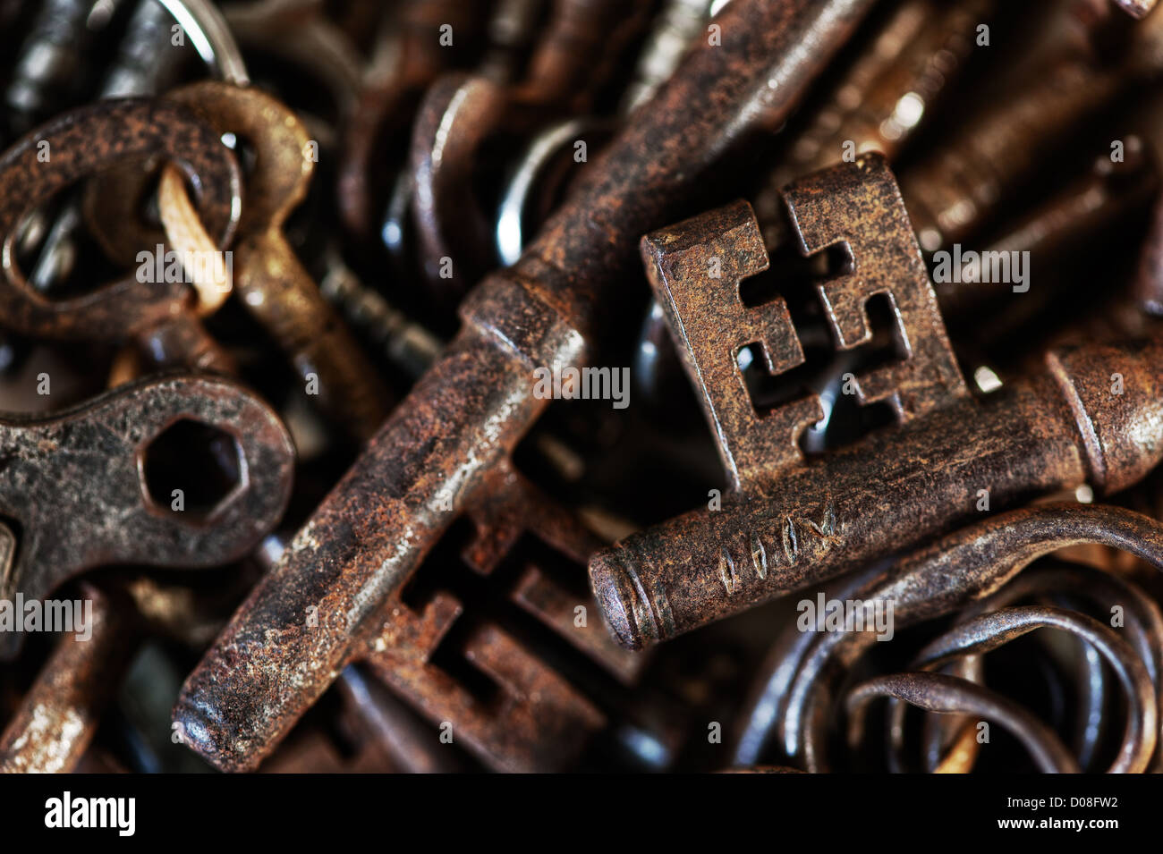 collection of old used rusty and shiny keys antique Victorian Edwardian turning mechanism lock foxed parchment Stock Photo