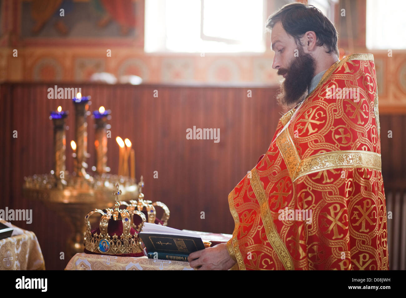 Orthodox priest during consecration in a church Stock Photo