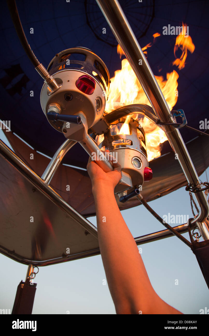 FLIGHT PILOT DURING THE LIGHTING OF THE GAS TO HEAT THE AIR IN THE HOT-AIR BALLOON EURE VALLEY EURE-ET-LOIR (28) FRANCE Stock Photo