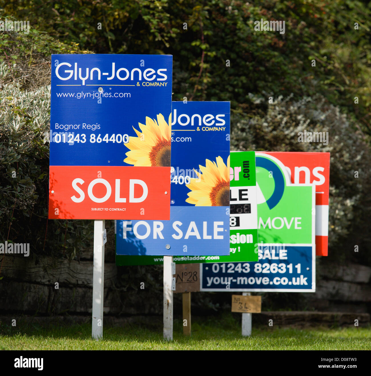 Business, Finance, Real Estate, Estate agents signs on posts advertising property for sale and sold. Stock Photo
