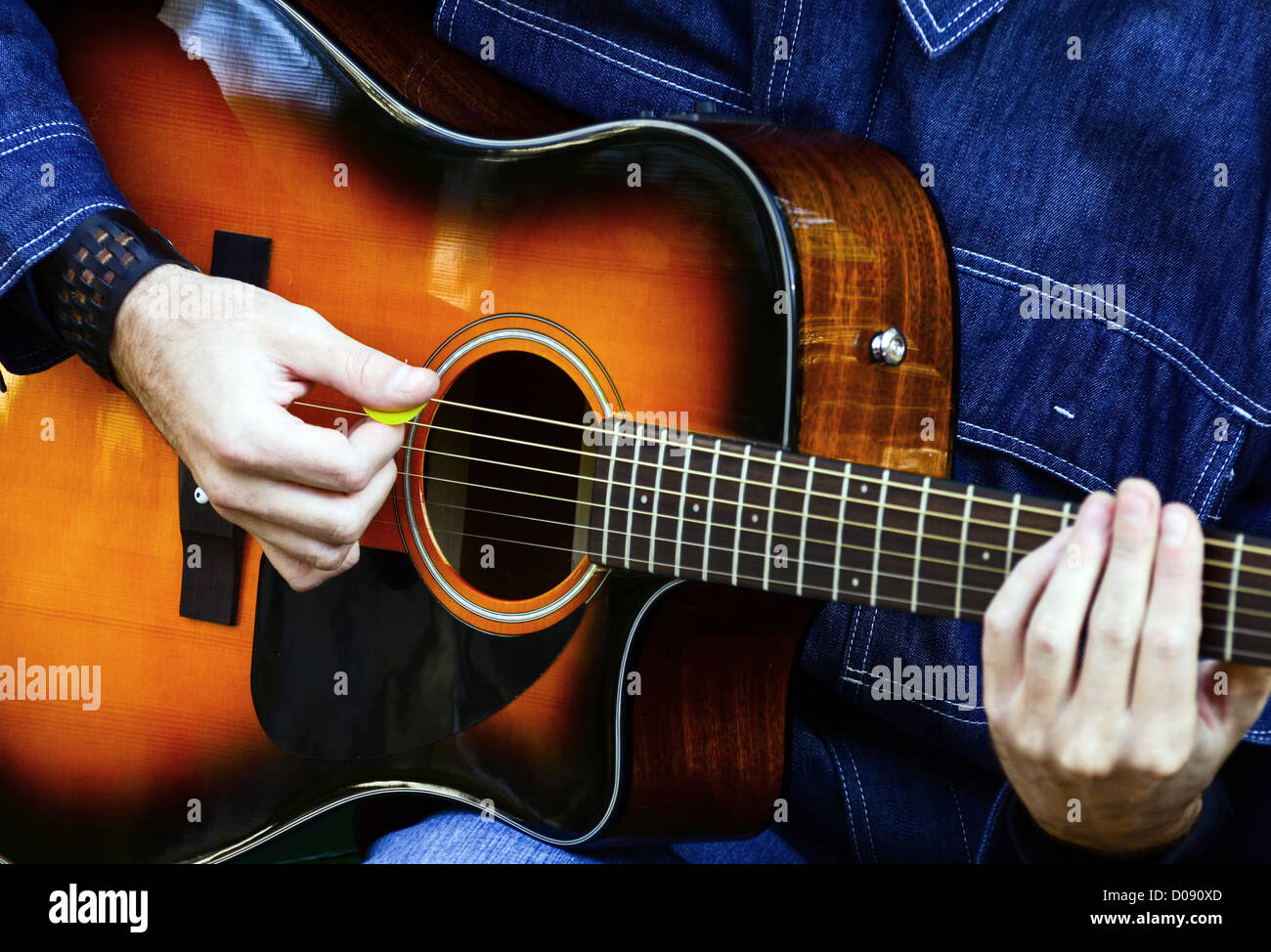 Man playing acoustic guitar Stock Photo