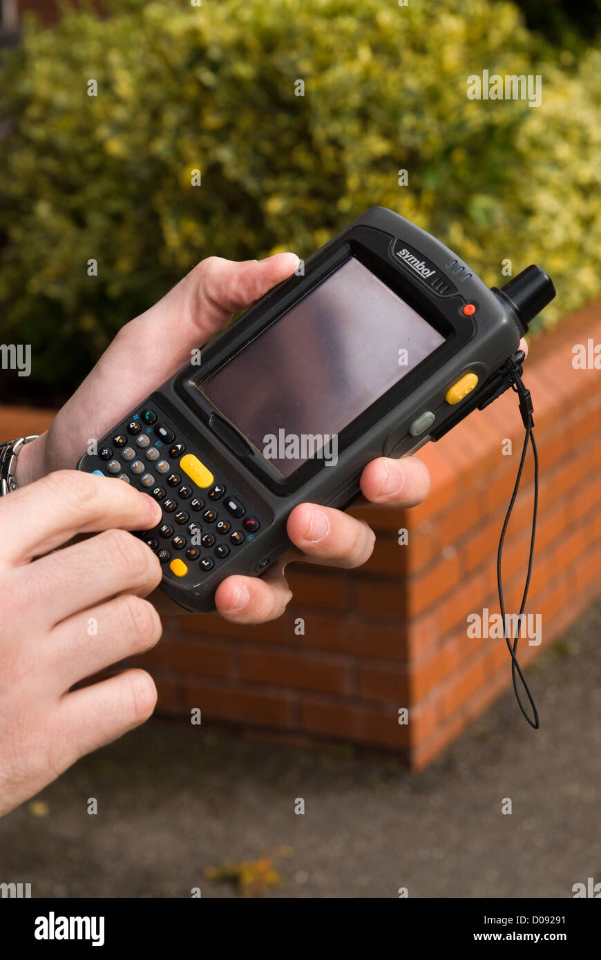 male hands holding a Personal digital assistant PDA outdoors Stock