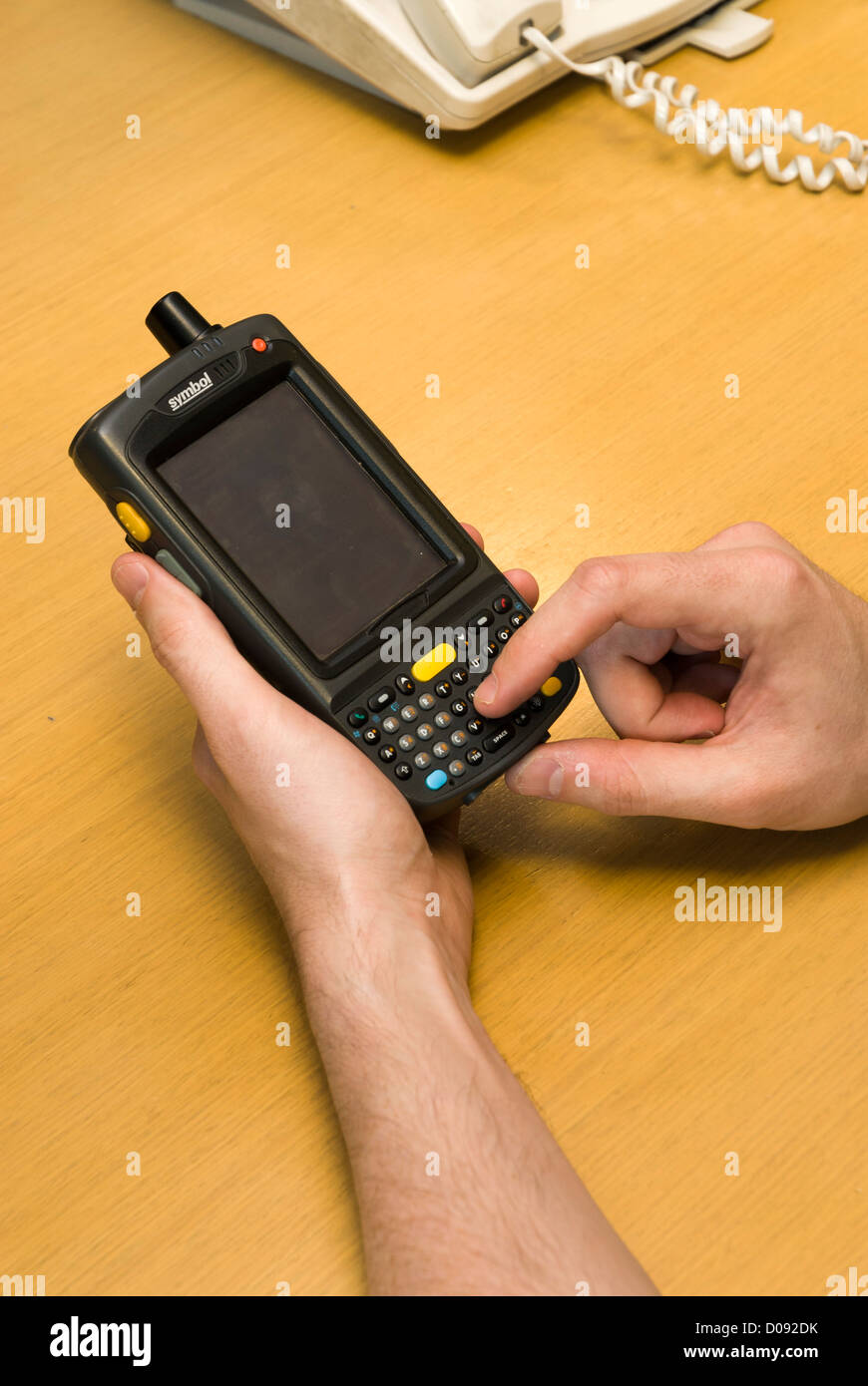male hands holding a Personal digital assistant PDA in an office on a