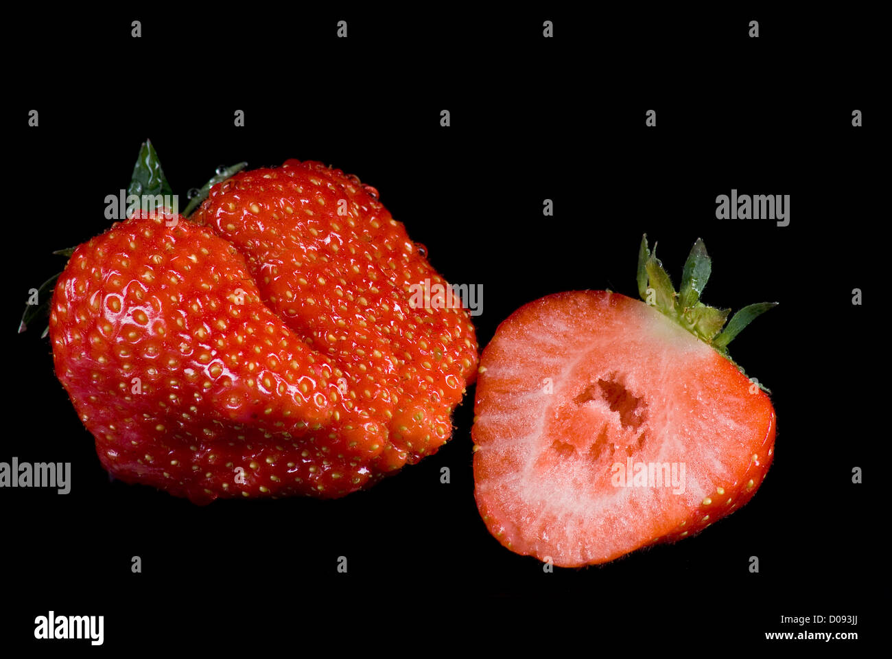 Strawberries on black background Stock Photo - Alamy