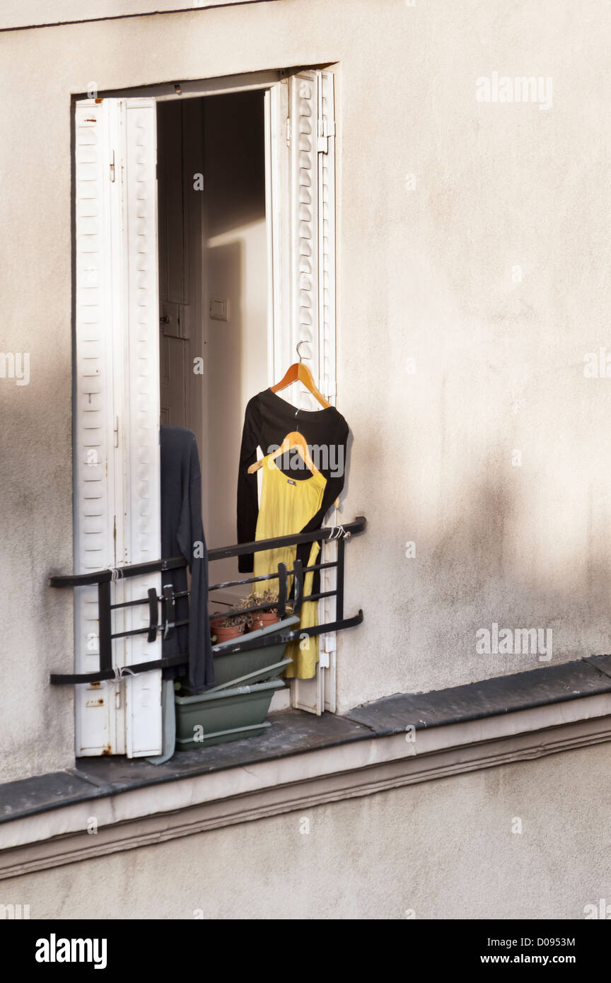 Paris, France: Dresses handing to dry and air at an apartment window Stock Photo