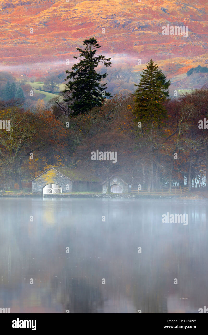 Boat House on Conniston Lake in the English Lake District during early morning mist and autumn colours Stock Photo