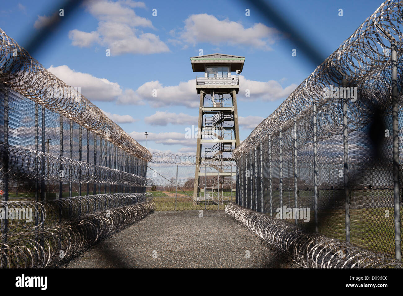 Prison fence, watch tower and barbed wire at Correctional Facility. High security. Stock Photo