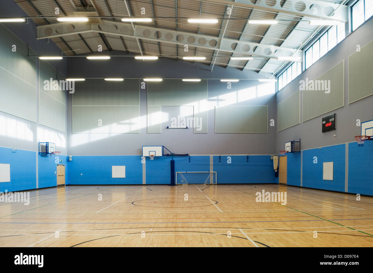 Gymnasium & sports hall in a modern secondary school, with bright sunlight shining in the windows. Stock Photo