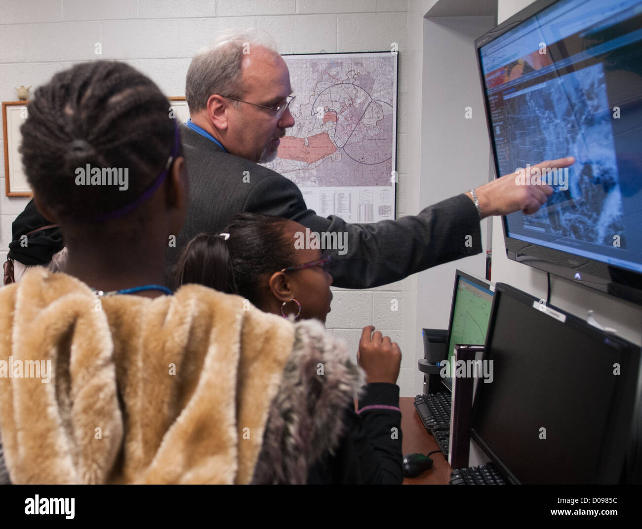 Richard Butler, weather station operations chief, shows students a