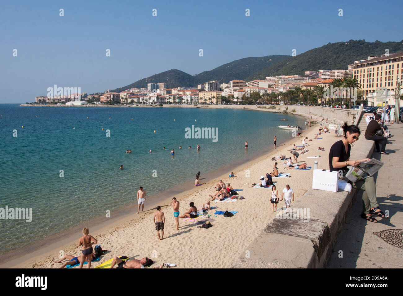 BATHERS AND STROLLERS ON THE BEACH OF AJACCIO SOUTHERN CORSICA (2A) FRANCE Stock Photo