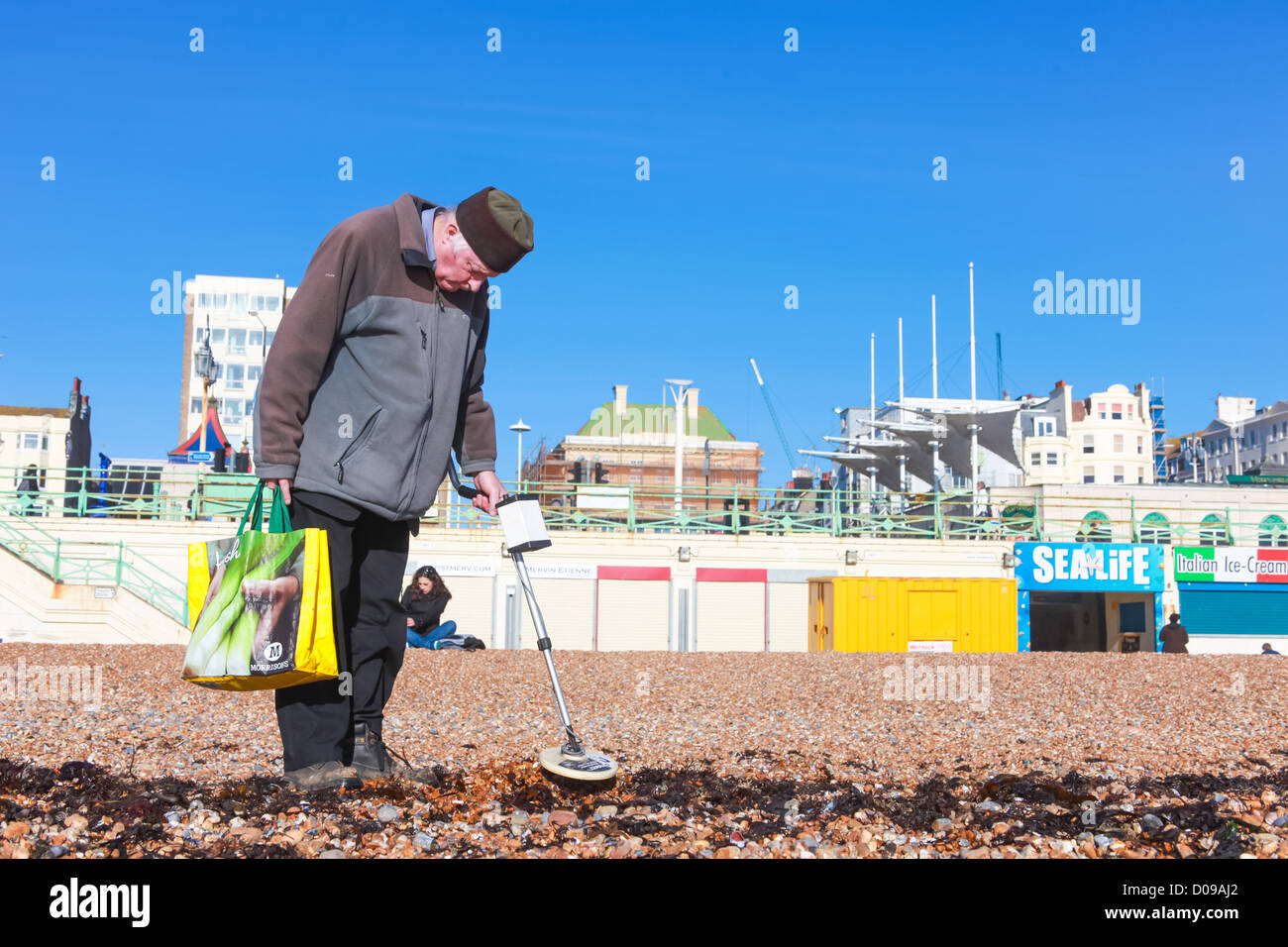 BRIGHTON, UK - FEBRUARY 8, 2011: Old man looking for metal objects on the in Brighton Stock Photo