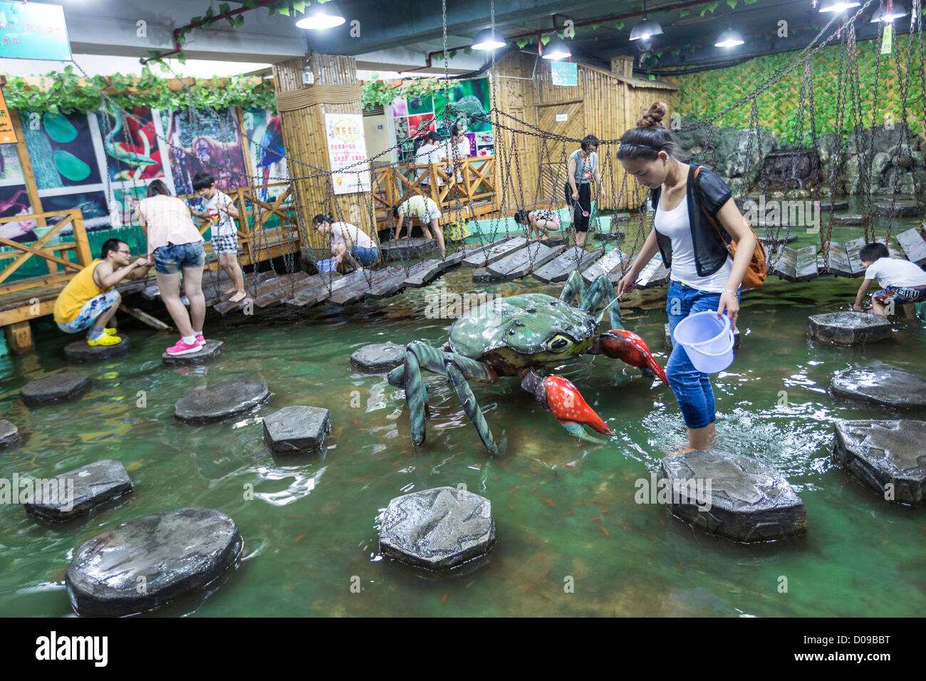 Chinese interact with marine life at the Shanghai Natural Wild Insect Kingdom in Shanghai, China Stock Photo