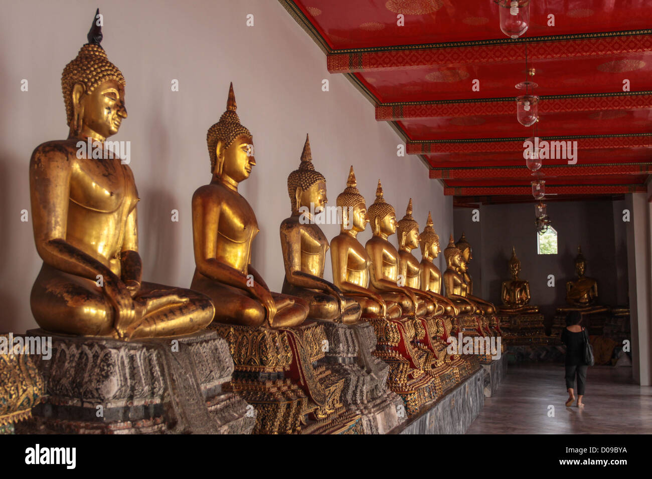 BUDDHA STATUES LINED UP INSIDE THE WAT PHO TEMPLE,BANGKOK THAILAND ASIA Stock Photo