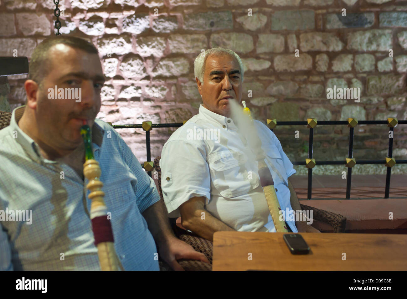 Two Turkish men smoking water pipes. Stock Photo