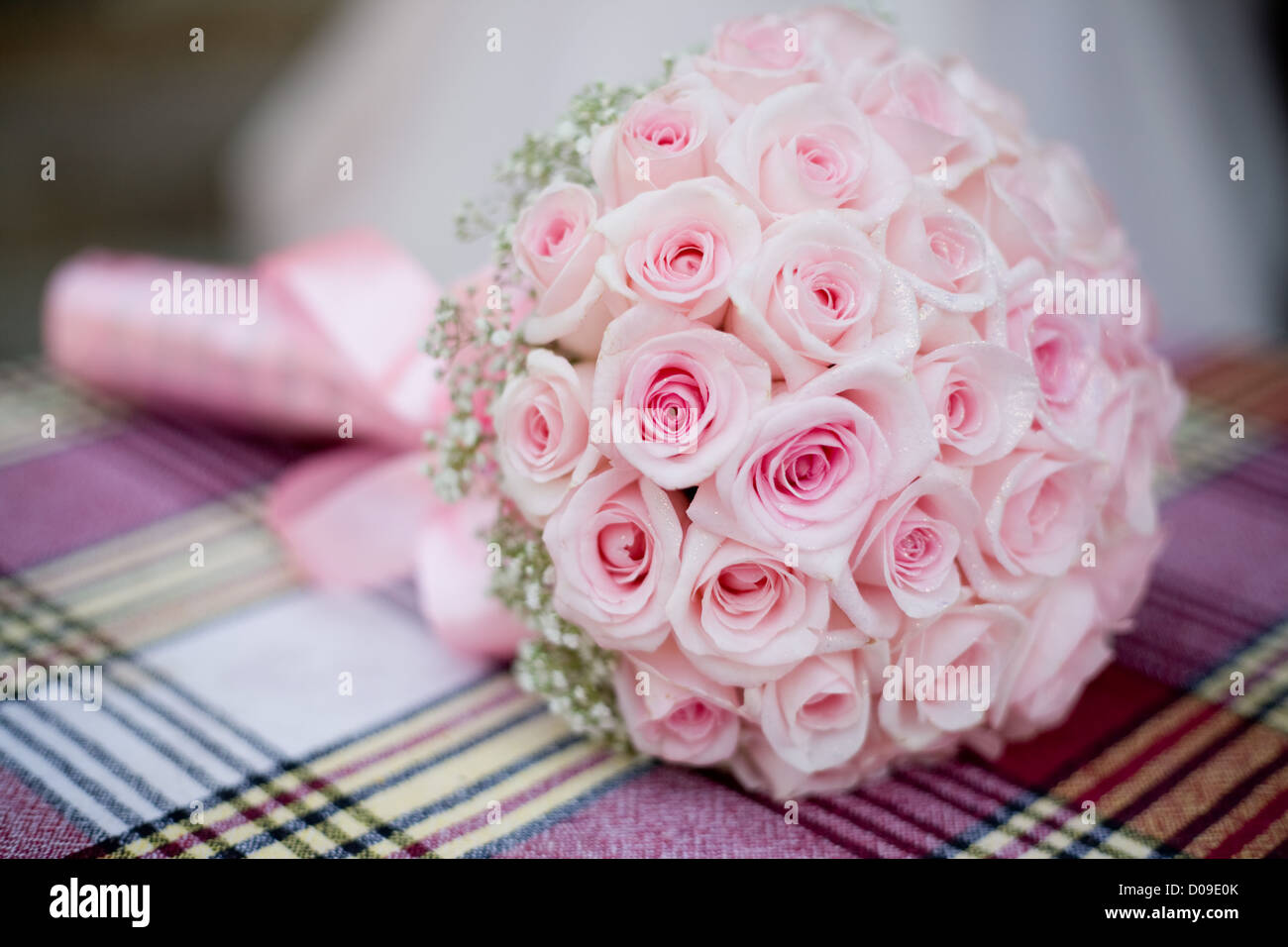 Wedding bouquet with pink roses on checkered backgdrop Stock Photo