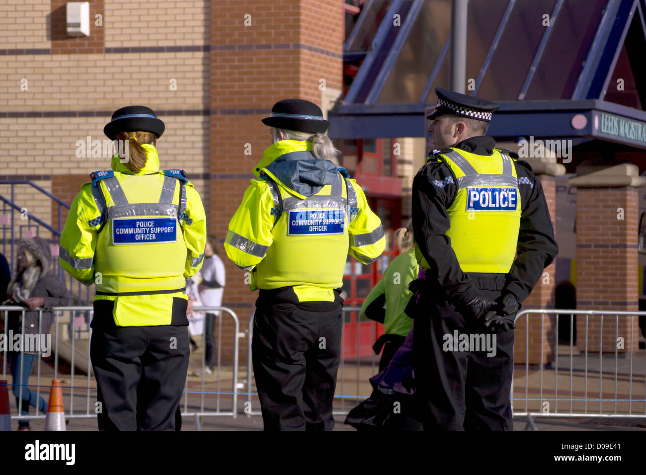 West Yorkshire Police officer standing with 2 Police Support Officer's standing opposite Leeds Crown Court Stock Photo