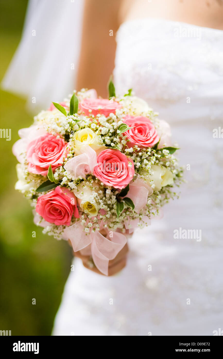 Wedding bouquet with white and pink roses in bride hand Stock Photo